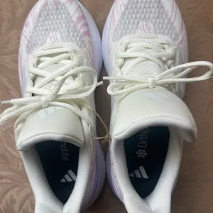 Adidas Women's running Shoes - White with purple accents. Size 8.5